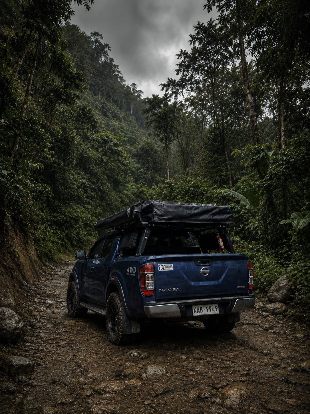 Dakila prototype vehicle with rooftop tent, rack, and lighting rig on a jungle trail